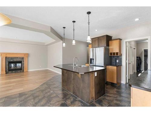 8 Sunset Close, Cochrane, AB - Indoor Photo Showing Kitchen With Fireplace