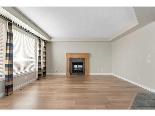 8 Sunset Close, Cochrane, AB - Indoor Photo Showing Living Room With Fireplace