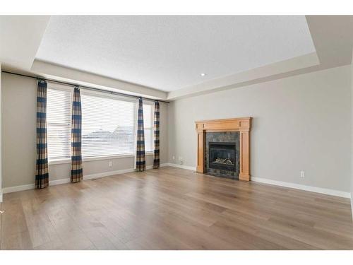 8 Sunset Close, Cochrane, AB - Indoor Photo Showing Living Room With Fireplace