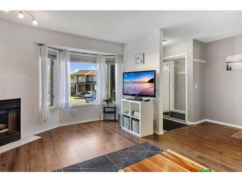 149 Patina Park Sw, Calgary, AB - Indoor Photo Showing Living Room With Fireplace