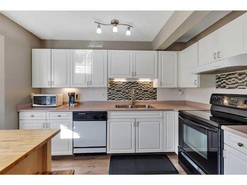 149 Patina Park Sw, Calgary, AB - Indoor Photo Showing Kitchen With Double Sink