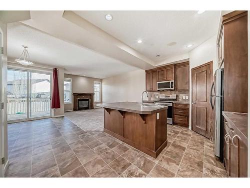 74 Brightoncrest Grove Se, Calgary, AB - Indoor Photo Showing Kitchen With Fireplace