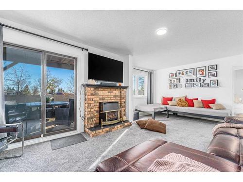 68 Coach Side Terrace Sw, Calgary, AB - Indoor Photo Showing Living Room With Fireplace