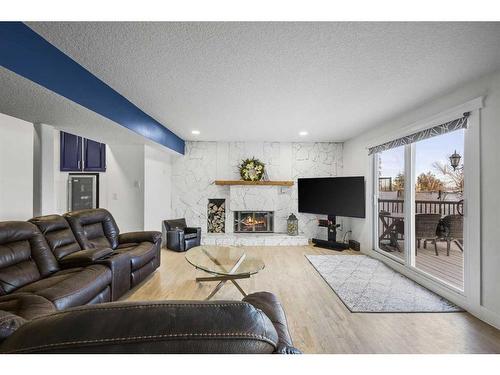 636 West Chestermere Drive, Chestermere, AB - Indoor Photo Showing Living Room With Fireplace