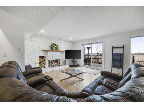 636 West Chestermere Drive, Chestermere, AB - Indoor Photo Showing Living Room With Fireplace