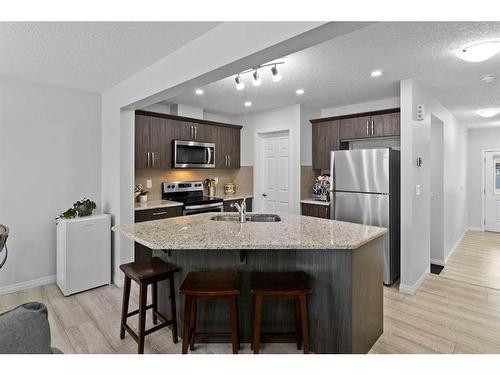 345 Hillcrest Square Sw, Airdrie, AB - Indoor Photo Showing Kitchen With Upgraded Kitchen