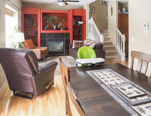 1105-720 Willowbrook Road Nw, Airdrie, AB - Indoor Photo Showing Living Room With Fireplace