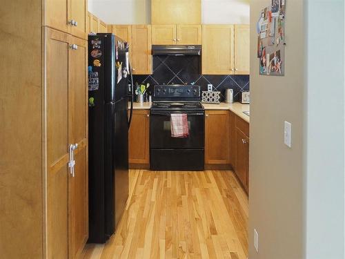 1105-720 Willowbrook Road Nw, Airdrie, AB - Indoor Photo Showing Kitchen