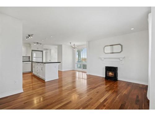 2425 13 Avenue, Didsbury, AB - Indoor Photo Showing Living Room With Fireplace