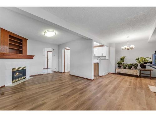 183 Coral Spings Circle Ne, Calgary, AB - Indoor Photo Showing Living Room With Fireplace