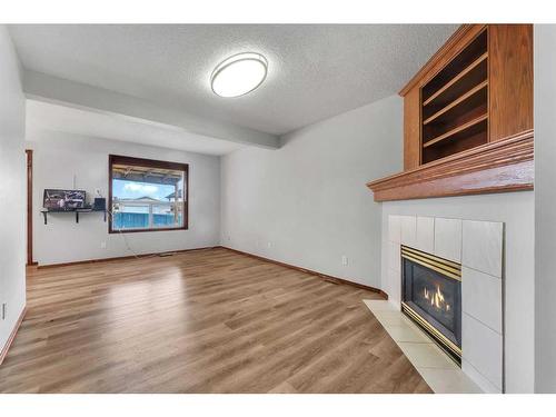 183 Coral Spings Circle Ne, Calgary, AB - Indoor Photo Showing Living Room With Fireplace