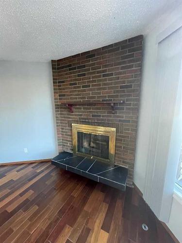 15-1919 69 Avenue Se, Calgary, AB - Indoor Photo Showing Other Room With Fireplace