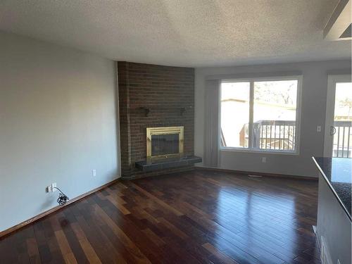 15-1919 69 Avenue Se, Calgary, AB - Indoor Photo Showing Living Room With Fireplace