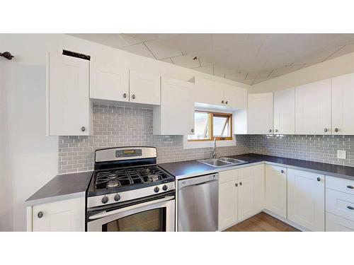 2313 22 Street, Nanton, AB - Indoor Photo Showing Kitchen With Double Sink