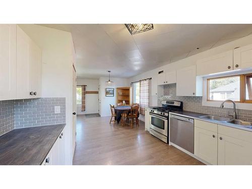 2313 22 Street, Nanton, AB - Indoor Photo Showing Kitchen With Double Sink