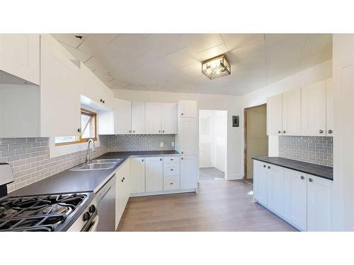 2313 22 Street, Nanton, AB - Indoor Photo Showing Kitchen With Double Sink