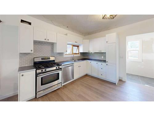 2313 22 Street, Nanton, AB - Indoor Photo Showing Kitchen With Double Sink