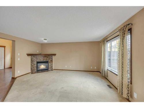 1920 New Brighton Drive Se, Calgary, AB - Indoor Photo Showing Living Room With Fireplace