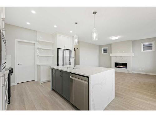 329 Copperhead Way Se, Calgary, AB - Indoor Photo Showing Kitchen With Fireplace With Upgraded Kitchen