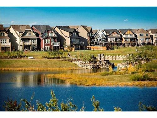 163 Masters Heights Se, Calgary, AB - Outdoor With Body Of Water With Facade