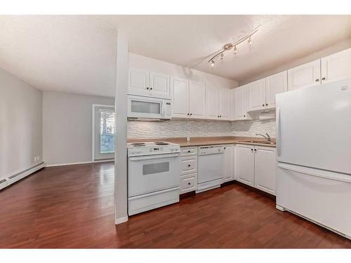 109-550 Prominence Rise Sw, Calgary, AB - Indoor Photo Showing Kitchen With Double Sink