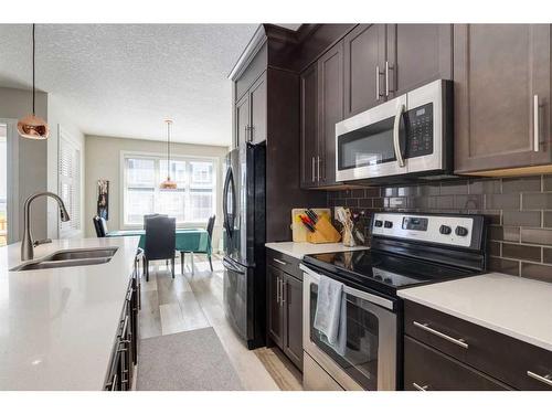 295 Silverado Plains Park Sw, Calgary, AB - Indoor Photo Showing Kitchen With Stainless Steel Kitchen With Double Sink With Upgraded Kitchen