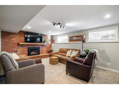 732 Lake Bonavista Drive Se, Calgary, AB - Indoor Photo Showing Living Room With Fireplace