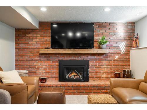 732 Lake Bonavista Drive Se, Calgary, AB - Indoor Photo Showing Living Room With Fireplace