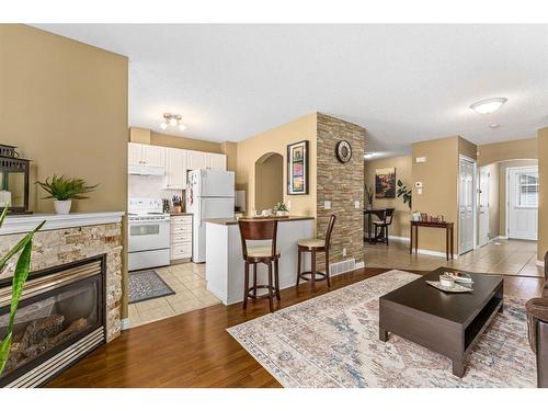 208 Stonemere Place, Chestermere, AB - Indoor Photo Showing Living Room With Fireplace