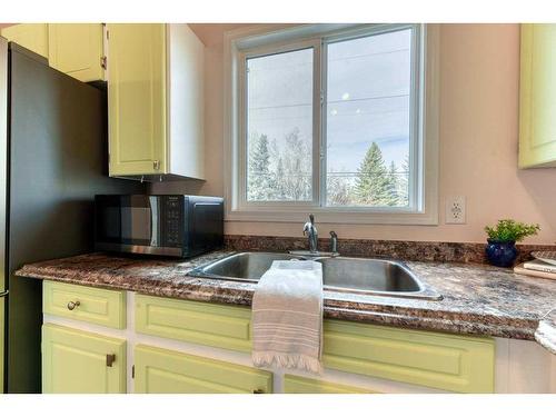 138 Oaktree Lane Sw, Calgary, AB - Indoor Photo Showing Kitchen With Double Sink