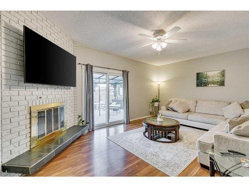 297 Queen Tamara Way Se, Calgary, AB - Indoor Photo Showing Living Room With Fireplace