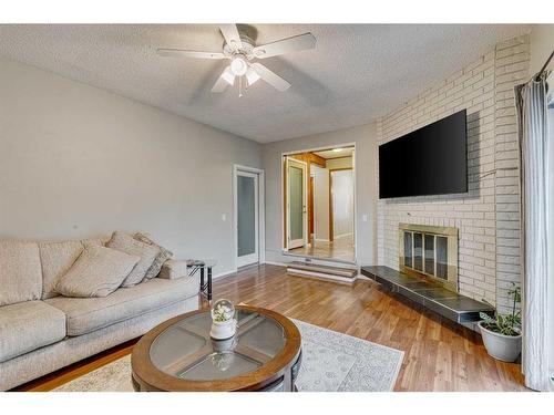 297 Queen Tamara Way Se, Calgary, AB - Indoor Photo Showing Living Room With Fireplace