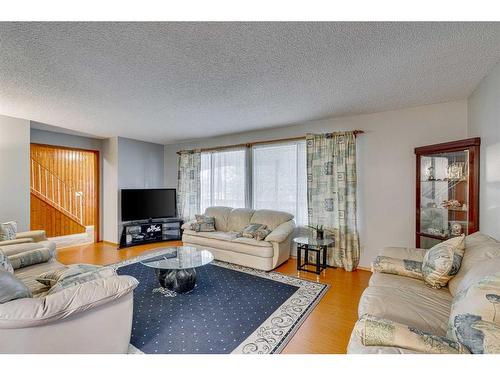 297 Queen Tamara Way Se, Calgary, AB - Indoor Photo Showing Living Room