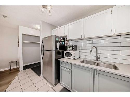 302-1712 38 Street Se, Calgary, AB - Indoor Photo Showing Kitchen With Double Sink