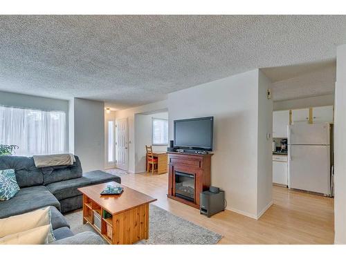 108-15403 Deer Run Drive Se, Calgary, AB - Indoor Photo Showing Living Room With Fireplace