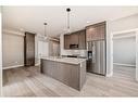 1305-111 Wolf Creek Drive Se, Calgary, AB  - Indoor Photo Showing Kitchen With Stainless Steel Kitchen With Upgraded Kitchen 