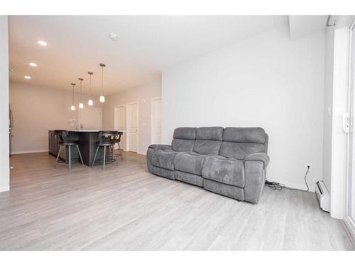 113-4150 Seton Drive Se, Calgary, AB - Indoor Photo Showing Living Room