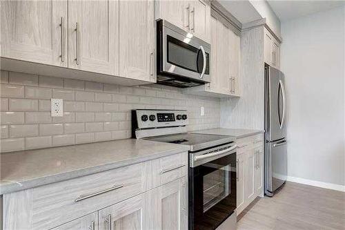 113-4150 Seton Drive Se, Calgary, AB - Indoor Photo Showing Kitchen With Stainless Steel Kitchen