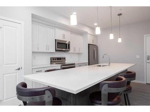 113-4150 Seton Drive Se, Calgary, AB - Indoor Photo Showing Kitchen With Stainless Steel Kitchen With Upgraded Kitchen