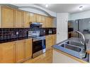 18 Covewood Circle Ne, Calgary, AB  - Indoor Photo Showing Kitchen With Double Sink 