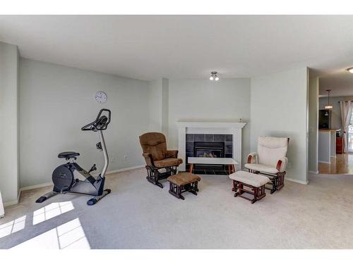 18 Covewood Circle Ne, Calgary, AB - Indoor Photo Showing Gym Room With Fireplace