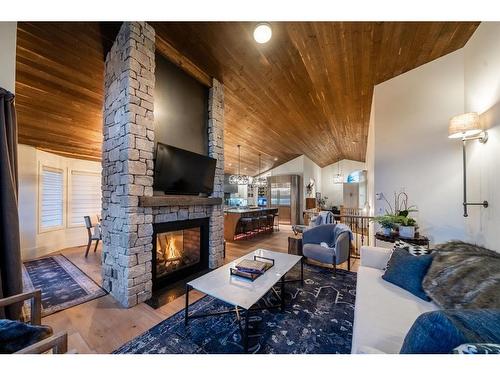 251 Gleneagles View, Cochrane, AB - Indoor Photo Showing Living Room With Fireplace