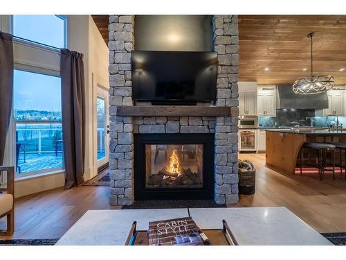 251 Gleneagles View, Cochrane, AB - Indoor Photo Showing Living Room With Fireplace