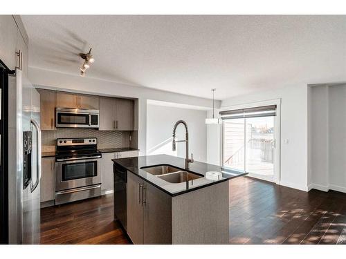 87 West Coach Manor Sw, Calgary, AB - Indoor Photo Showing Kitchen With Stainless Steel Kitchen With Double Sink With Upgraded Kitchen