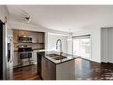 87 West Coach Manor Sw, Calgary, AB  - Indoor Photo Showing Kitchen With Stainless Steel Kitchen With Double Sink With Upgraded Kitchen 