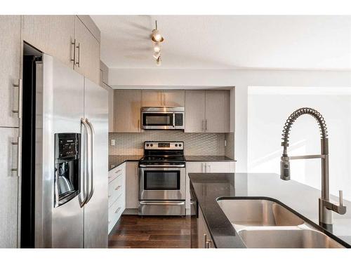 87 West Coach Manor Sw, Calgary, AB - Indoor Photo Showing Kitchen With Stainless Steel Kitchen With Double Sink