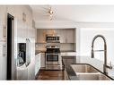 87 West Coach Manor Sw, Calgary, AB  - Indoor Photo Showing Kitchen With Stainless Steel Kitchen With Double Sink 