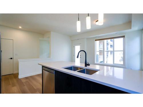 144-2117 81 Street Sw, Calgary, AB - Indoor Photo Showing Kitchen With Double Sink