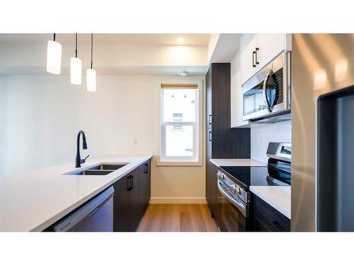 144-2117 81 Street Sw, Calgary, AB - Indoor Photo Showing Kitchen With Double Sink With Upgraded Kitchen