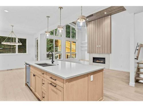 251B Three Sisters Drive, Canmore, AB - Indoor Photo Showing Kitchen With Fireplace With Double Sink